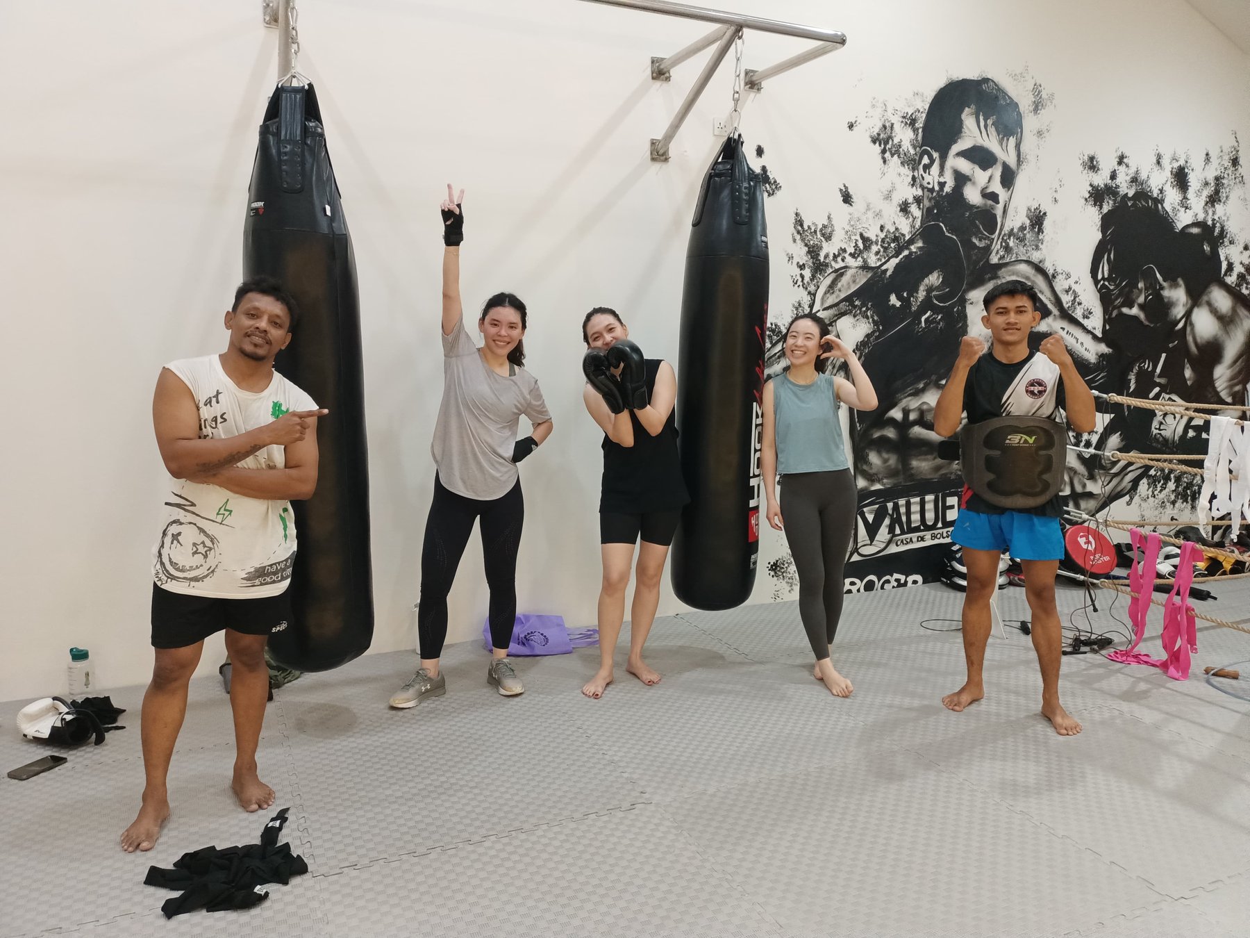 Members with the coach by the heavy bags