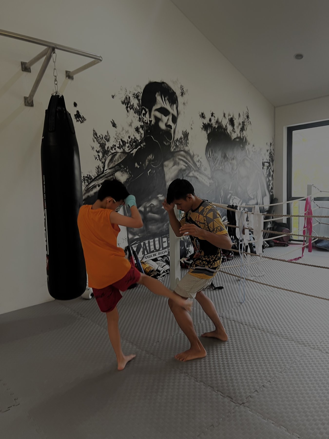 Kid training a kick with the coach